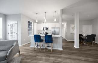 A modern kitchen with a dining table and chairs at Harbor Pointe Apartments, Bayonne, NJ, 07002