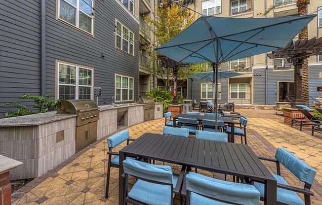 a patio with a table and chairs and an umbrella