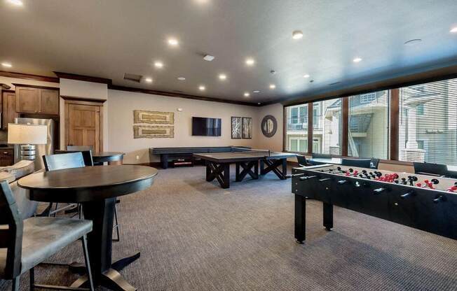 a game room with a foosball table and ping pong table