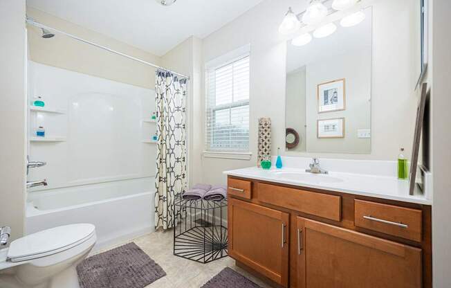 A bathroom with a white toilet, a white sink, and a white bathtub.