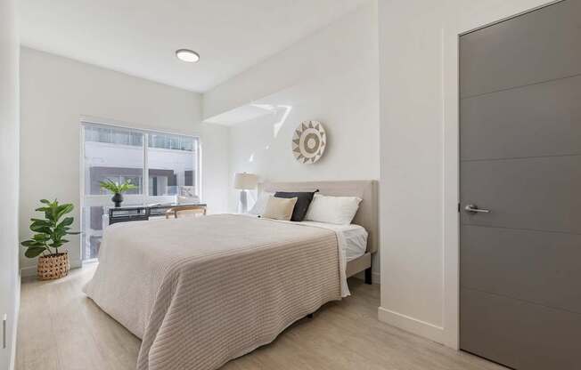 a bedroom with a bed and a window