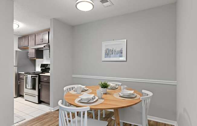 a dining room with a table and chairs and a kitchen