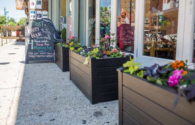 A sign outside a store that says "Try It Happy Hour".