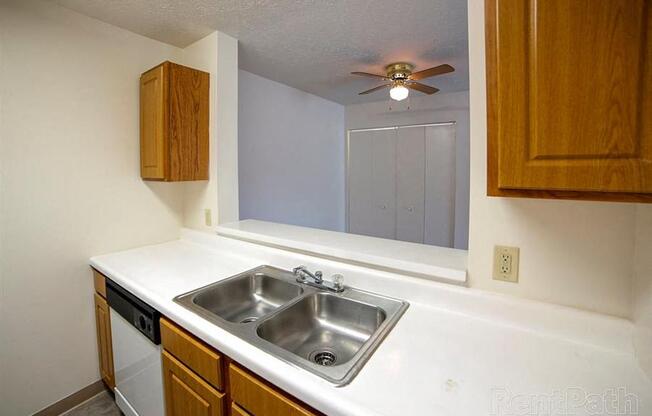 Stainless Steel Sink With Faucet at Creekside Square Apartments, Indianapolis