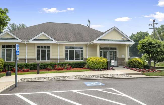 a house with a parking lot and a street sign in front of it