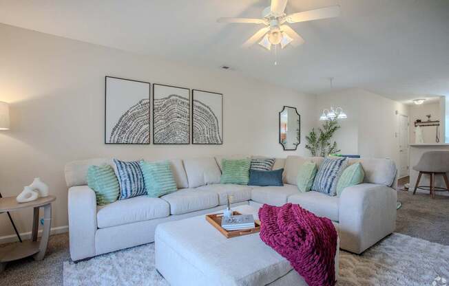 A living room with a white couch and a coffee table.