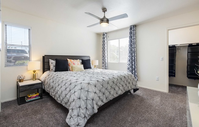 a bedroom with a bed and a ceiling fan