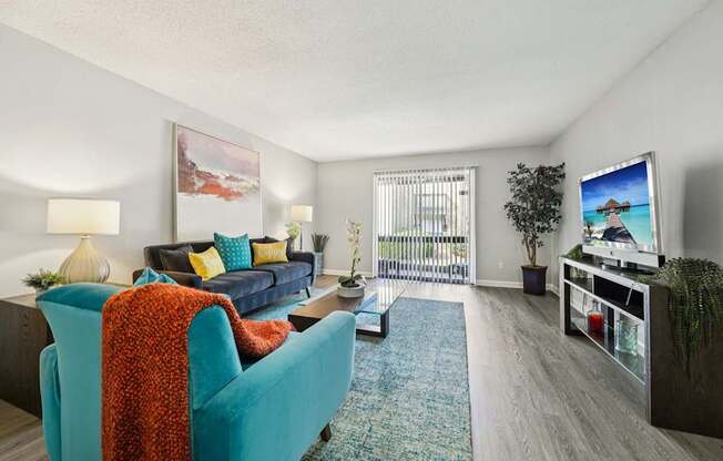 A living room with a blue couch and a television.