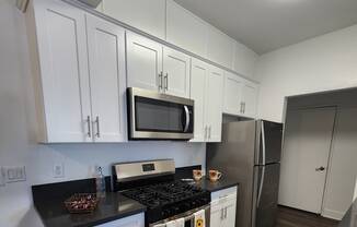 Upgraded kitchen with shaker doors, quartz countertops and wood-like flooring