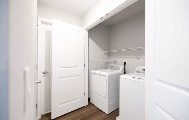 A white laundry room with a washer and dryer.