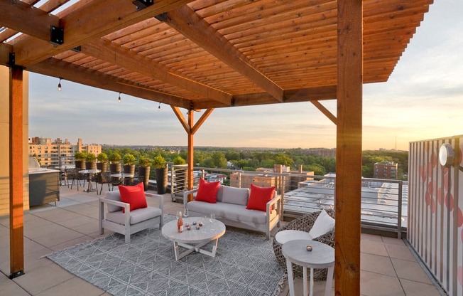 a roof deck with couches and tables