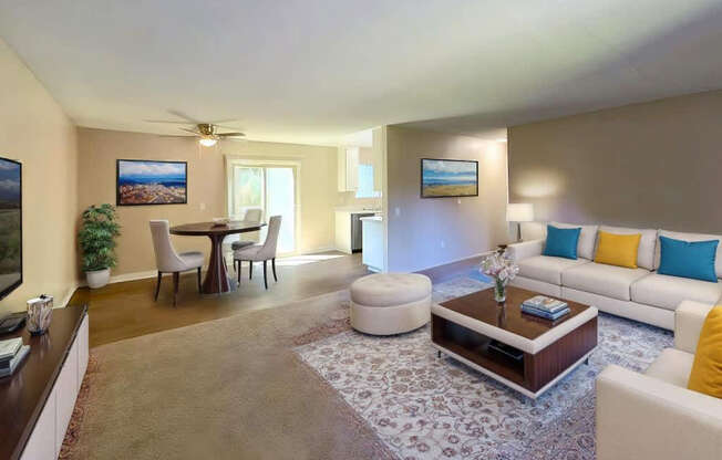 A living room with a white couch, a coffee table, and a ceiling fan.