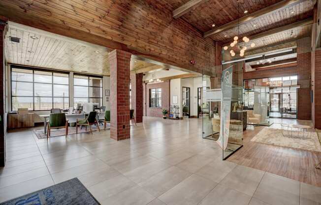 the interior of a building with exposed brick and glass walls and a large lobby