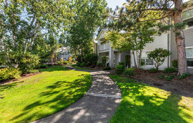 A residential area with a pathway and greenery.