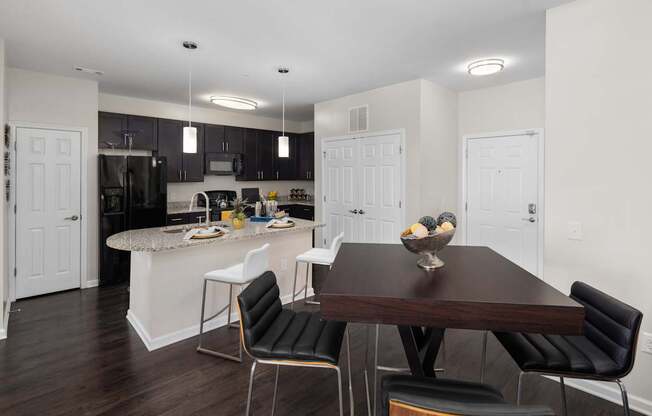 A modern kitchen with a dining table and chairs.