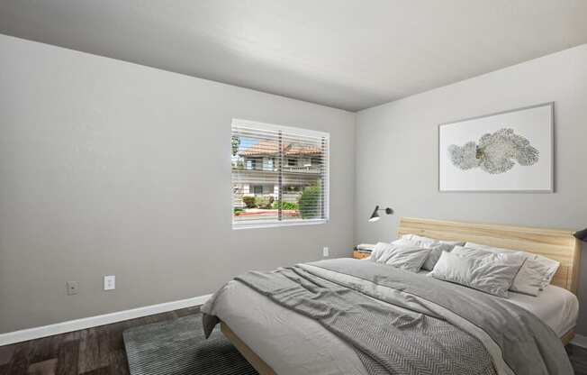 a bedroom with a bed and a window