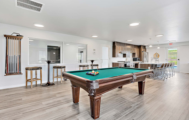 a recreation room with a pool table and bar