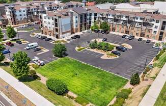 an aerial view of an empty parking lot in front of an apartment building