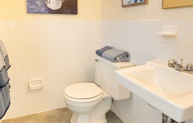 White bathroom with a sink and a toilet at Rockdale Gardens Apartments*, Baltimore, MD