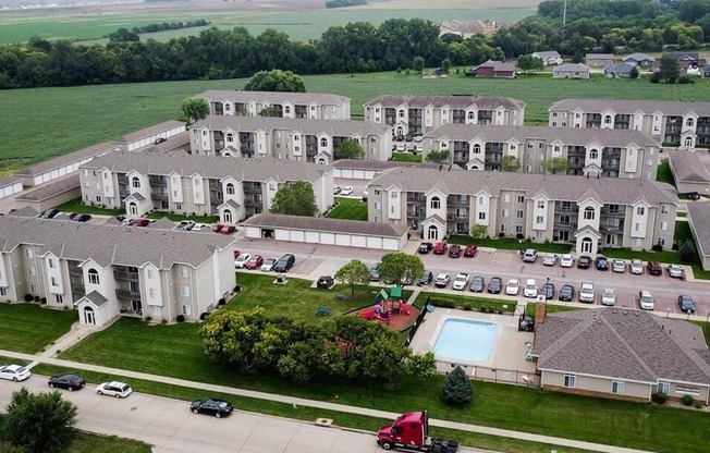 an aerial view of an apartment complex with a pool