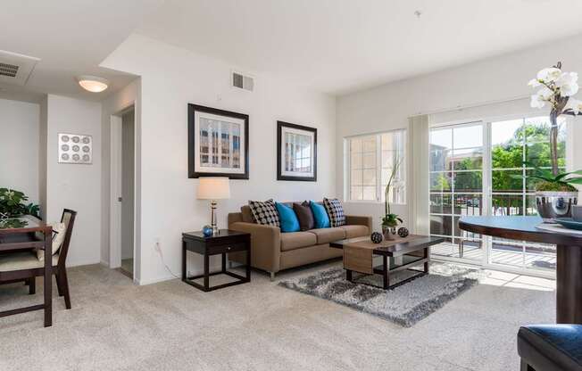 A living room with a couch, a chair, a coffee table, and a lamp.