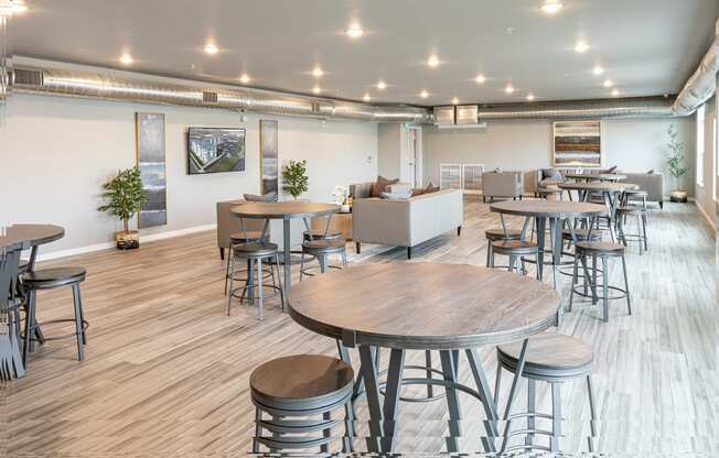 a communal area with tables and chairs in a large room