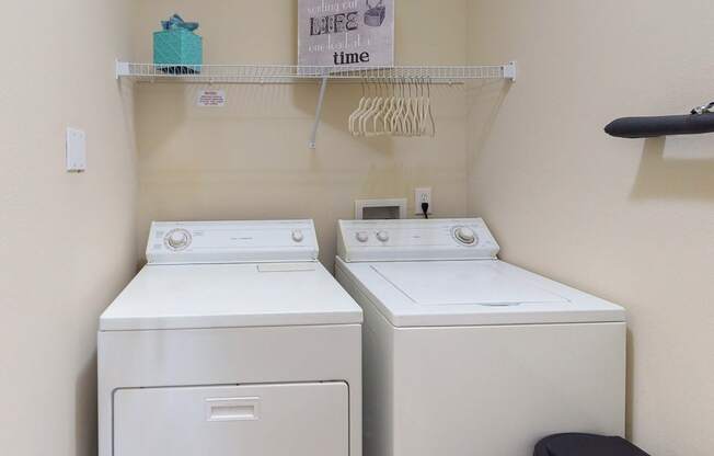 two washers and a dryer in a laundry room