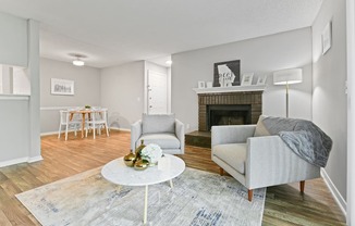 a living room with two chairs and a fireplace