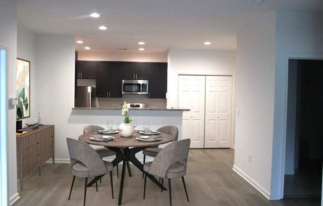 a kitchen and dining room with a table and chairs