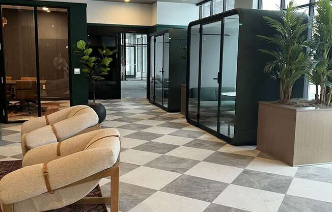 A room with a checkered floor and a chair in the foreground.