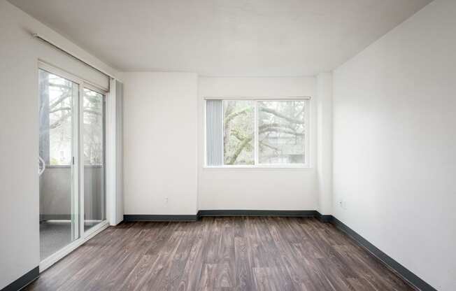 an empty room with white walls and a window