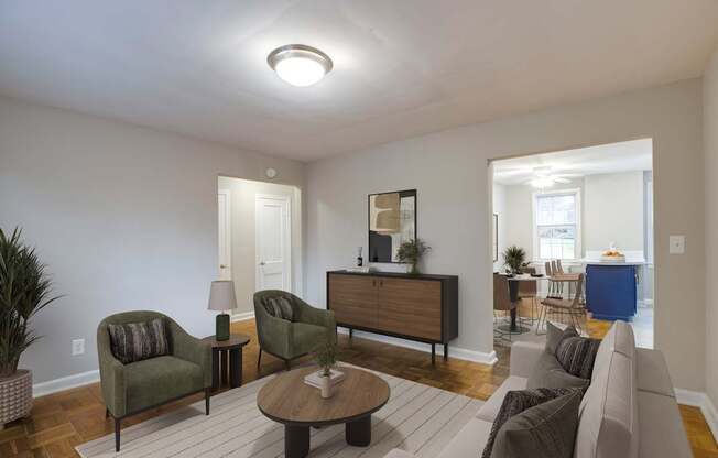 A living room with a brown and green sofa, a wooden cabinet, and a coffee table.