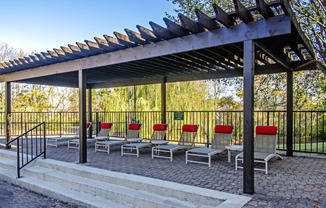 a group of chairs under awning in a park