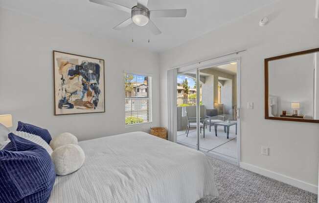 a bedroom with a bed and a ceiling fan