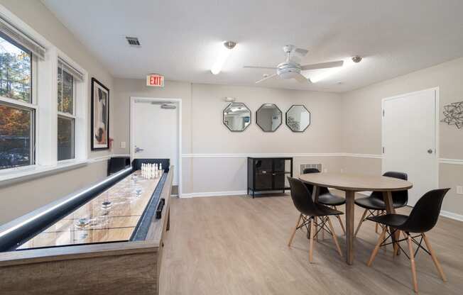 a dining room with a table and chairs