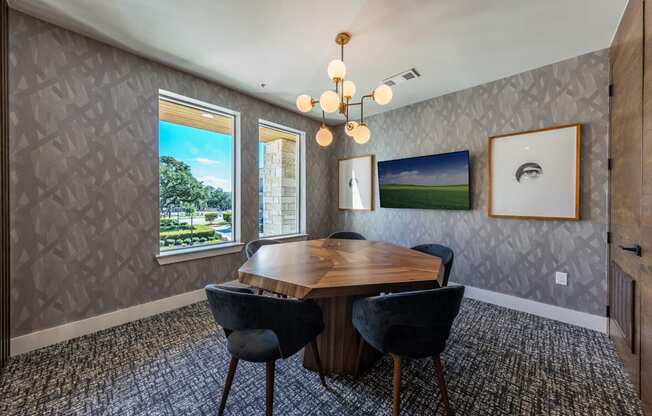 A dining room with a wooden table and chairs.