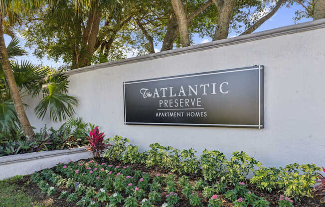 A sign that says Atlantic Reserve in front of some trees.