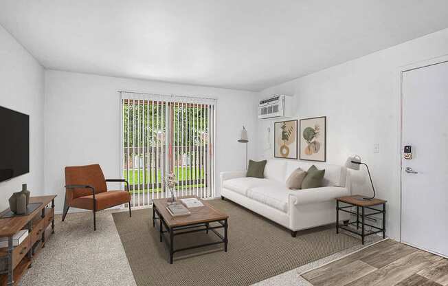 A living room leading to a private balcony at Granada Apartments, Jackson, 49202