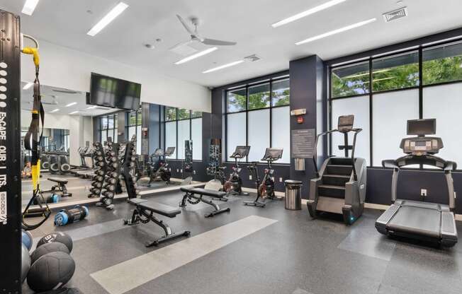 a gym with cardio equipment and weights at Metro 303, New York 