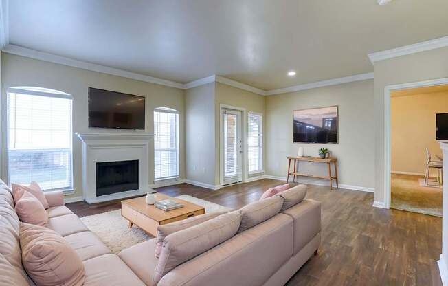 A living room with a couch, coffee table, and television.