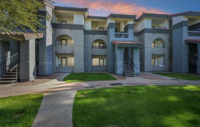 Sunset view of Stillwater apartment buildings with a courtyard in the foreground.