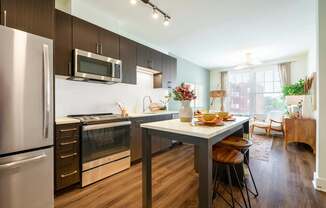 A modern kitchen with a dining table and chairs.