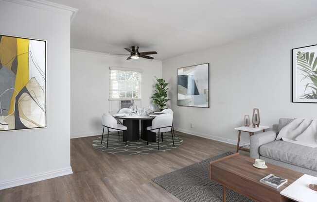 a dining room with a table and chairs and a ceiling fan