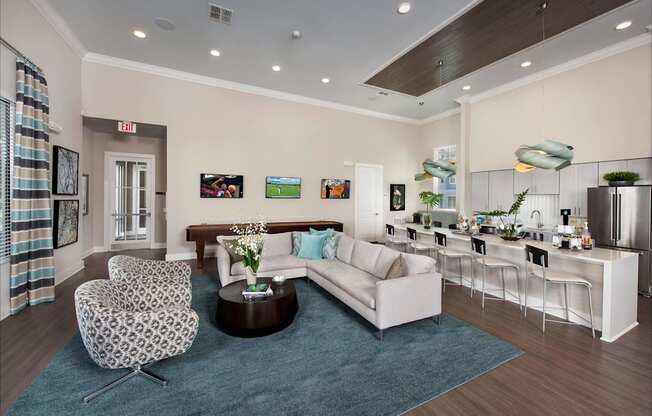 A modern living room with a white sofa, a patterned chair, and a coffee table.