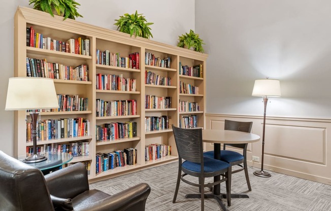 a library with a table and chairs and shelves of books