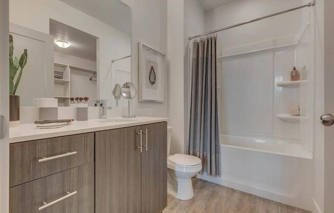 a bathroom with a shower and a toilet and a sink  at Affinity 56 Apartments in West Jordan, Utah