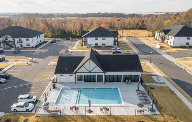 an aerial view of a building with a swimming pool