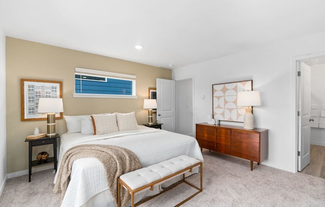 a master bedroom with a bed and a dresser
