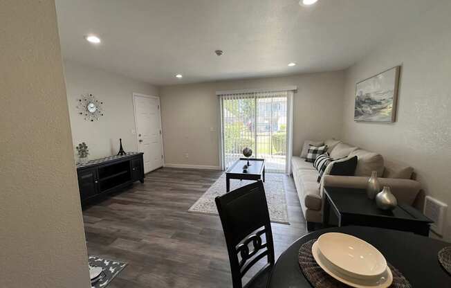 A dining room with a black table and chairs.