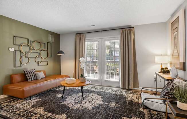 A living room with a brown leather sofa, a coffee table, and a rug.